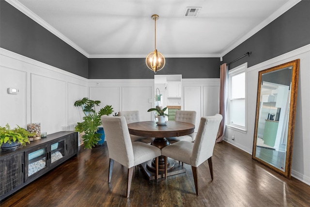 2923 Live Oak Ave, Waco, TX 76708 - dining room featuring a decorative wall, dark wood finished floors, ornamental molding, wainscoting, and a chandelier