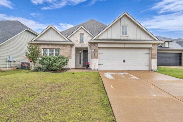 view of front of property with board and batten siding, concrete driveway, a front yard, and central AC