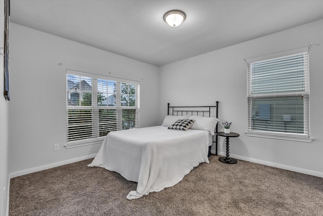 carpeted bedroom featuring baseboards