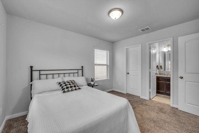 bedroom featuring carpet flooring, baseboards, and connected bathroom