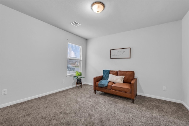 sitting room with carpet and baseboards