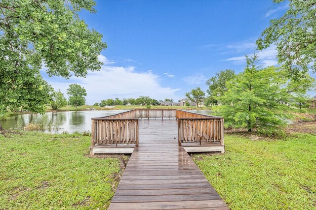 dock with a yard and a deck with water view