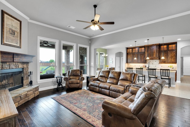 102 Willowbrook Dr, Waxahachie, TX 75165 - living area featuring ceiling fan, arched walkways, healthy amount of natural light, baseboards, and crown molding