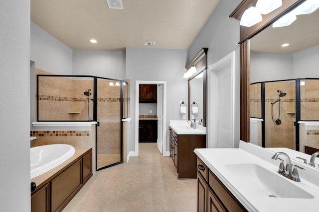 102 Willowbrook Dr, Waxahachie, TX 75165 - bathroom with a stall shower, a bath, tile patterned flooring, two vanities, and recessed lighting