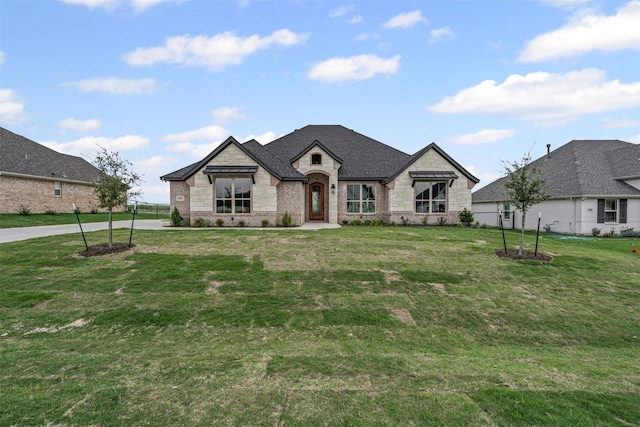 11612 Panther Dr, Godley, TX 76044 - french country inspired facade with stone siding, a front lawn, and brick siding