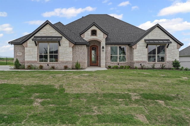 11612 Panther Dr, Godley, TX 76044 - french country inspired facade featuring stone siding, a shingled roof, a front lawn, and brick siding
