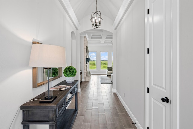 11612 Panther Dr, Godley, TX 76044 - corridor featuring arched walkways, coffered ceiling, beamed ceiling, baseboards, and a chandelier