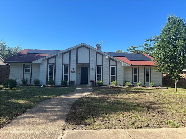 1104 Hillsdale Dr, Richardson, TX 75081 - view of front of property featuring solar panels, brick siding, and a front lawn