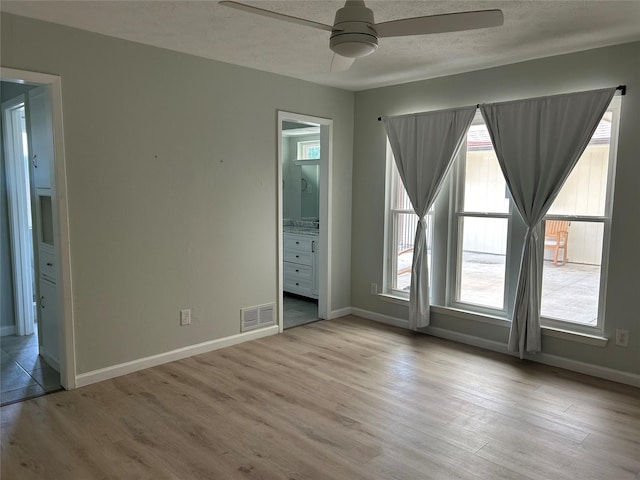 1104 Hillsdale Dr, Richardson, TX 75081 - spare room featuring a ceiling fan, plenty of natural light, wood finished floors, and a textured ceiling