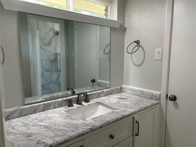 1104 Hillsdale Dr, Richardson, TX 75081 - bathroom with vanity, a marble finish shower, and a textured wall