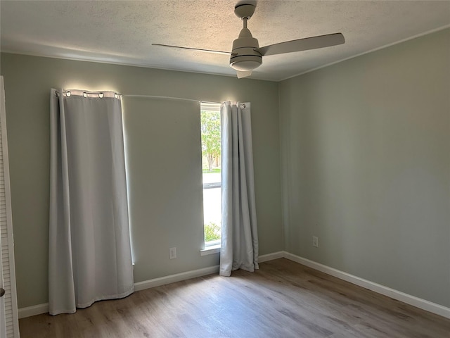 1104 Hillsdale Dr, Richardson, TX 75081 - unfurnished room featuring wood finished floors, ceiling fan, plenty of natural light, baseboards, and a textured ceiling
