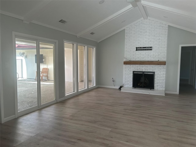 1104 Hillsdale Dr, Richardson, TX 75081 - unfurnished living room with plenty of natural light, wood finished floors, a brick fireplace, and baseboards