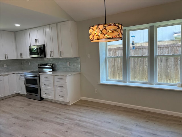 1104 Hillsdale Dr, Richardson, TX 75081 - kitchen featuring appliances with stainless steel finishes, baseboards, decorative backsplash, white cabinetry, and recessed lighting