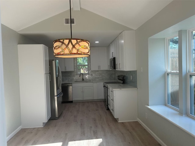 1104 Hillsdale Dr, Richardson, TX 75081 - kitchen with appliances with stainless steel finishes, light wood finished floors, a sink, and backsplash