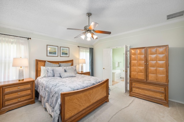 bedroom with light carpet, ornamental molding, a textured ceiling, ensuite bathroom, and ceiling fan