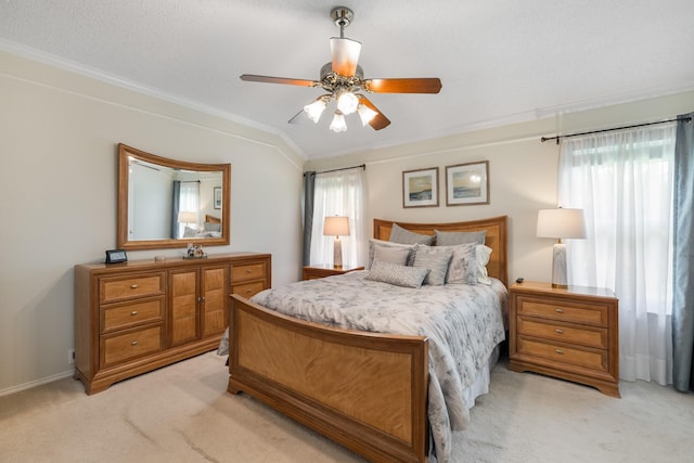 bedroom featuring light colored carpet, ornamental molding, and a ceiling fan