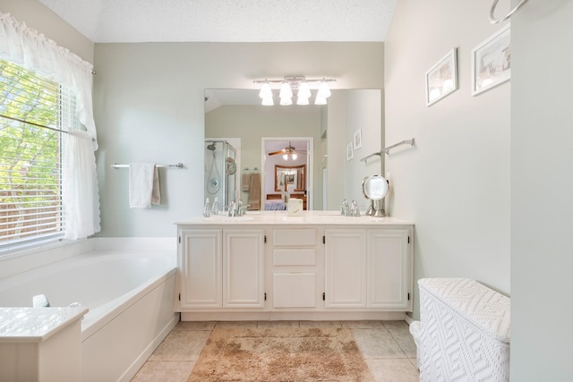 bathroom with a shower stall, tile patterned floors, a bath, double vanity, and a ceiling fan
