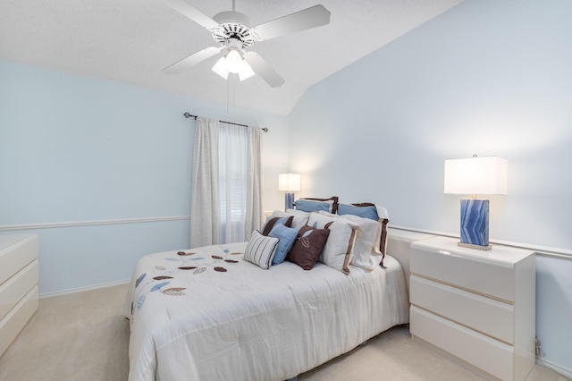 bedroom featuring light colored carpet, vaulted ceiling, and ceiling fan
