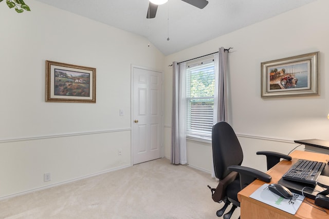 office space with ceiling fan, lofted ceiling, light colored carpet, and baseboards