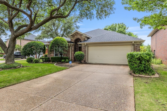 view of front of house featuring a garage, driveway, a front yard, and brick siding