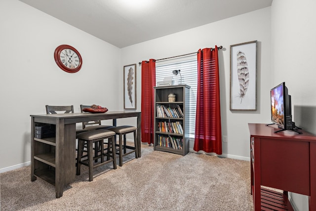 dining room featuring carpet floors, baseboards, and a desk