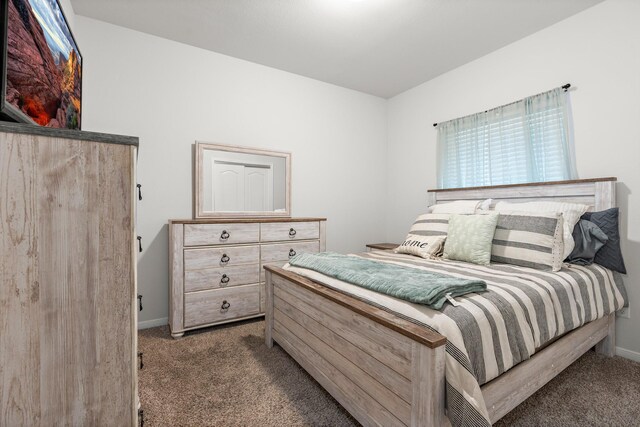 bedroom featuring carpet flooring and baseboards