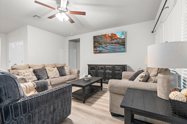 living area featuring a ceiling fan and light wood-type flooring