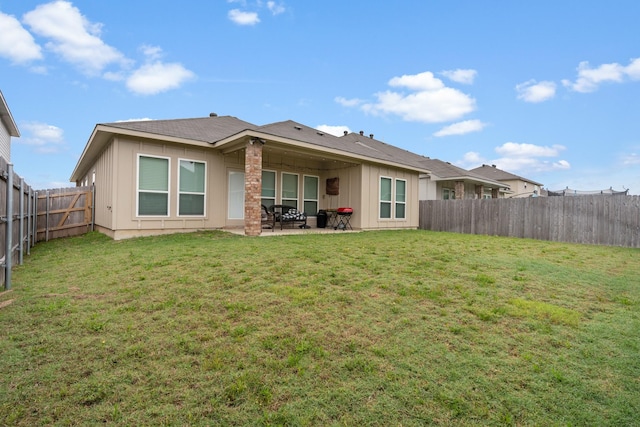 rear view of property featuring a patio area and board and batten siding