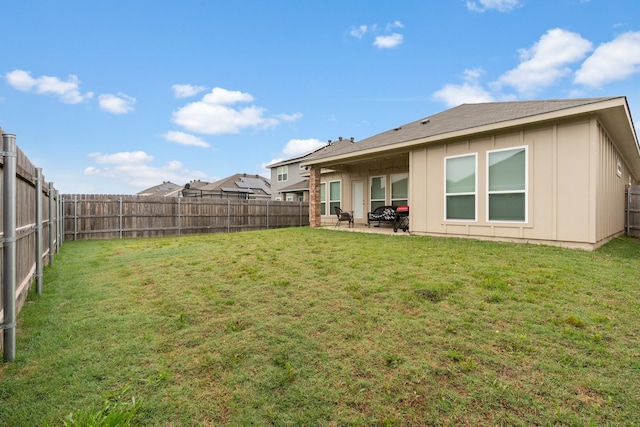 rear view of house featuring board and batten siding and a patio area