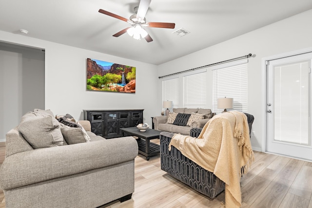 living room featuring ceiling fan and light wood-type flooring