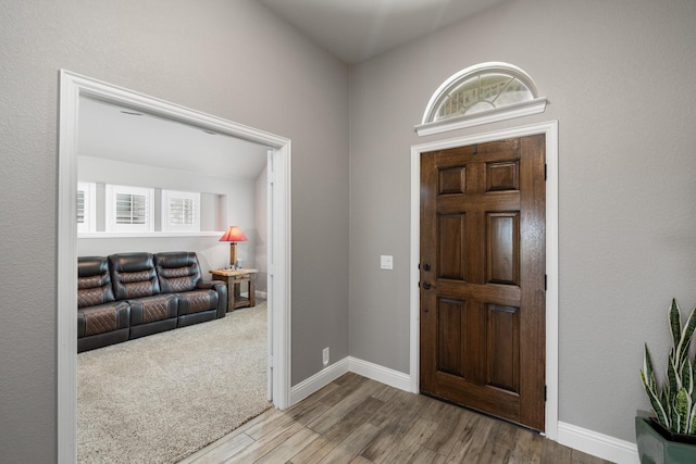 entrance foyer with wood finished floors and baseboards