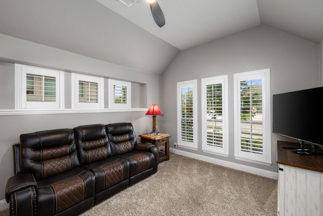 carpeted living area featuring a ceiling fan, vaulted ceiling, baseboards, and plenty of natural light