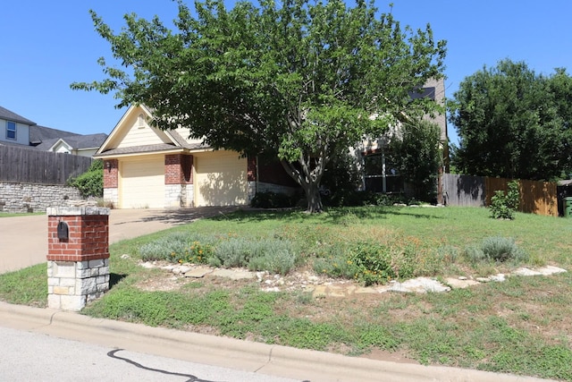 103 Apache Ct, Glen Rose, TX 76043 - obstructed view of property with brick siding, a garage, and driveway