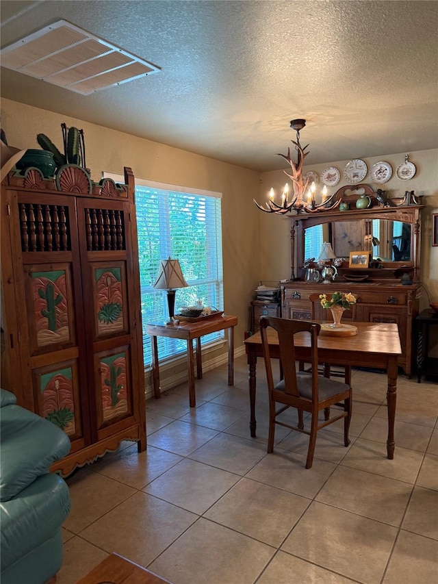 103 Apache Ct, Glen Rose, TX 76043 - dining room featuring a chandelier, a textured ceiling, and light tile patterned flooring