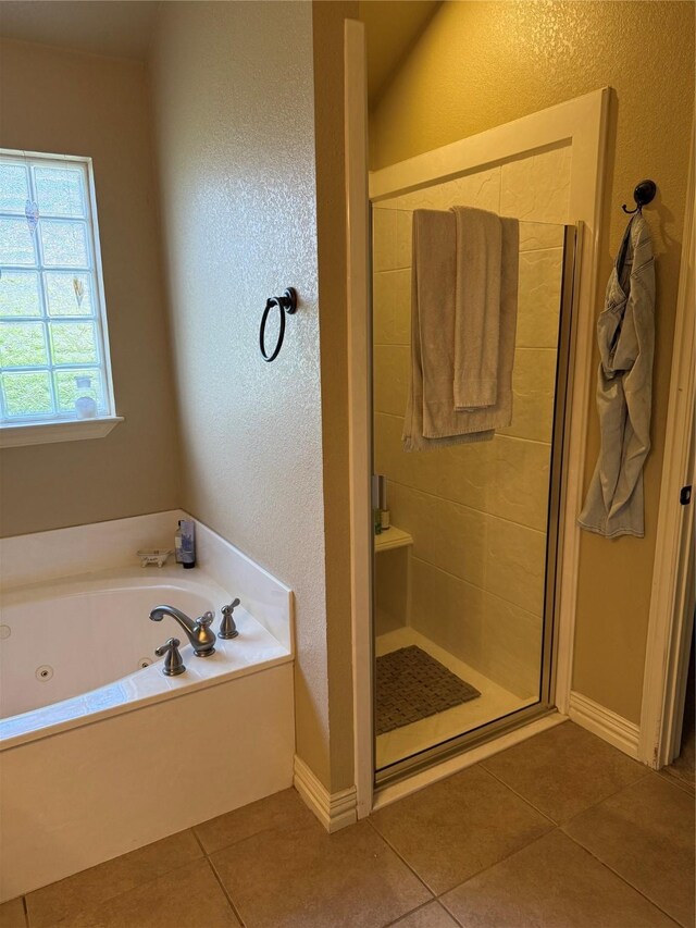 103 Apache Ct, Glen Rose, TX 76043 - bathroom featuring tile patterned flooring, a tub with jets, a stall shower, a textured wall, and baseboards