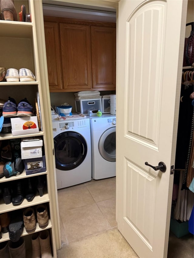 103 Apache Ct, Glen Rose, TX 76043 - laundry room featuring washing machine and dryer, light tile patterned flooring, and cabinet space