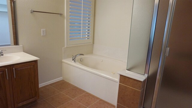 full bath with a bath, tile patterned flooring, vanity, an enclosed shower, and baseboards