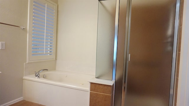 full bath with a garden tub, a shower stall, and tile patterned flooring
