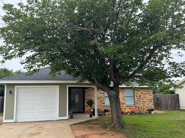 3902 Georgetown Dr, Abilene, TX 79602 - view of front of house with driveway, an attached garage, brick siding, and roof with shingles