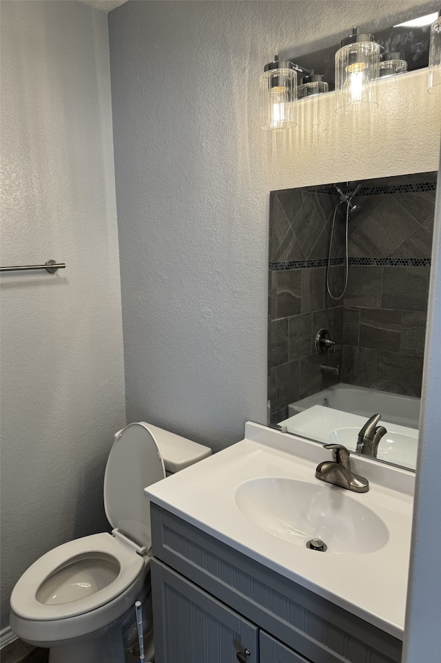 3902 Georgetown Dr, Abilene, TX 79602 - bathroom with toilet, vanity, shower / tub combination, and a textured wall