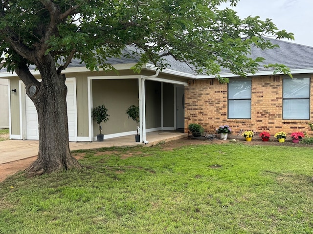 3902 Georgetown Dr, Abilene, TX 79602 - view of front of house with a shingled roof, a front lawn, brick siding, and a garage