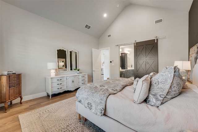 15102 Crape Myrtle Rd, Frisco, TX 75035 - bedroom with high vaulted ceiling, light wood-style flooring, a barn door, baseboards, and recessed lighting