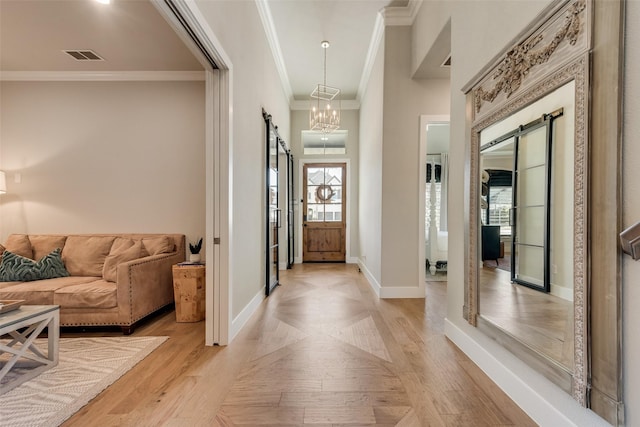 15102 Crape Myrtle Rd, Frisco, TX 75035 - entryway with a barn door, ornamental molding, baseboards, and a chandelier