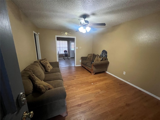503 Cates Dr, Kaufman, TX 75142 - living area featuring wood finished floors, ceiling fan, a textured ceiling, and baseboards