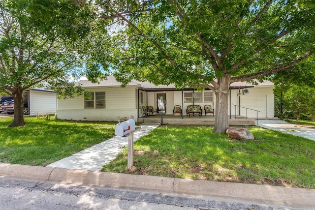 view of front of house with a front yard and covered porch