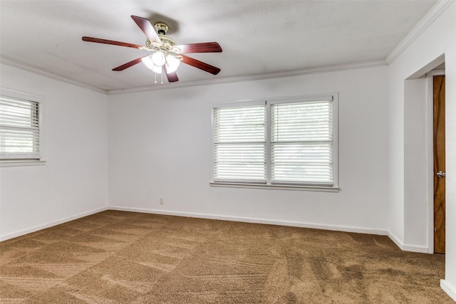 empty room with carpet, plenty of natural light, ornamental molding, and ceiling fan