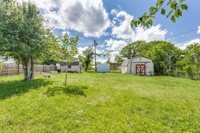 view of yard featuring a storage shed and an outbuilding