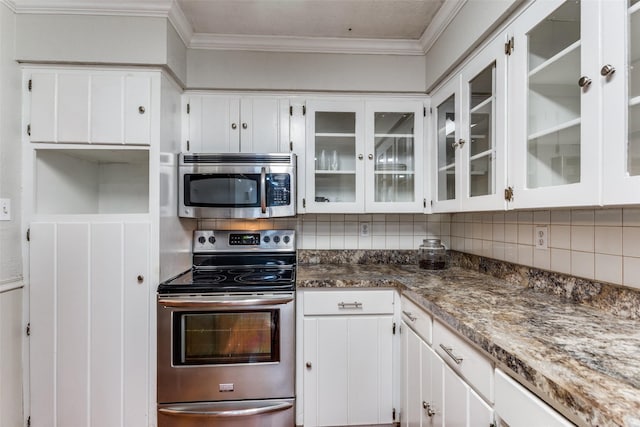 kitchen with appliances with stainless steel finishes, crown molding, white cabinetry, decorative backsplash, and glass insert cabinets