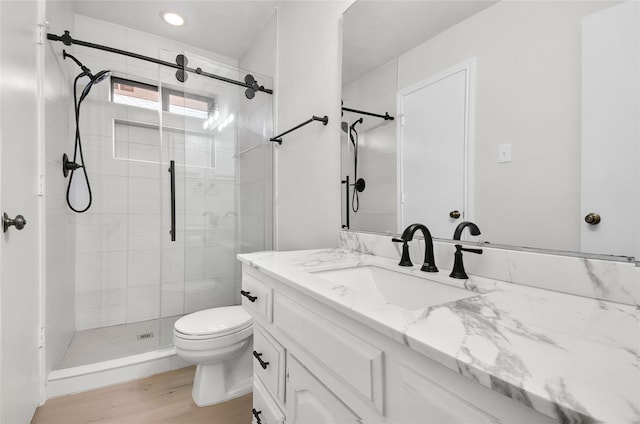 3022 Westforest Dr, Dallas, TX 75229 - full bath featuring a stall shower, wood finished floors, toilet, vanity, and recessed lighting