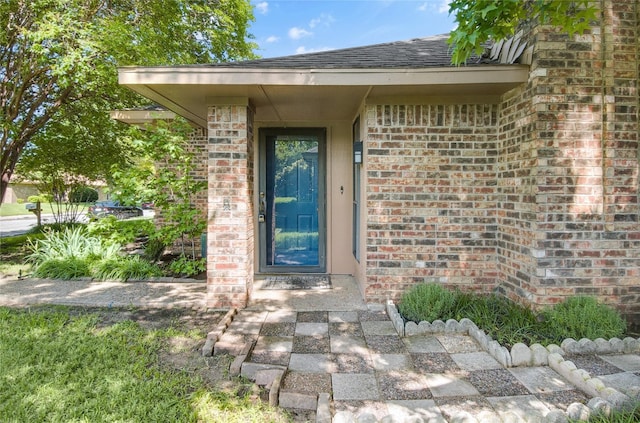 3022 Westforest Dr, Dallas, TX 75229 - view of exterior entry featuring brick siding and a shingled roof
